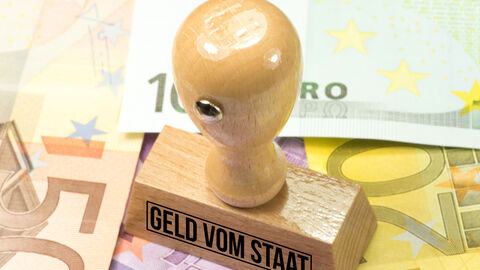 Euro-Banknoten und ein Stempel mit dem Aufdruck Geld vom Staat Euro-Banknoten und ein Stempel mit dem Aufdruck Geld vom Staat