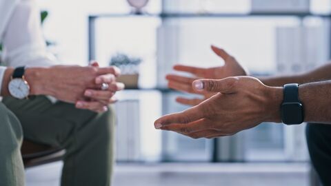 Situation einer Psychotherapiesitzung Nahaufnahme eines nicht erkennbaren Psychologen und der Hände des Patienten während einer Therapiesitzung